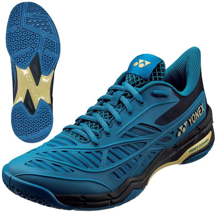 The Yonex Power Cushion Cascade Drive Badminton Shoes in Teal Blue feature a textured sole for enhanced grip and shock absorption. These shoes boast a sleek design with black and gold accents, along with prominent logos on the side and tongue, offering both style and stability on the court.