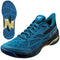 The Yonex Power Cushion Cascade Drive Badminton Shoes in Teal Blue feature a textured sole for enhanced grip and shock absorption. These shoes boast a sleek design with black and gold accents, along with prominent logos on the side and tongue, offering both style and stability on the court.