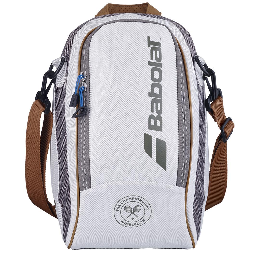 A sleek and sporty grey Babolat Wimbledon Cooler Badminton Bag, featuring a central zippered pocket with the brand logo and a Wimbledon emblem at the bottom. It includes an adjustable strap and incorporates classic Wimbledon colors.