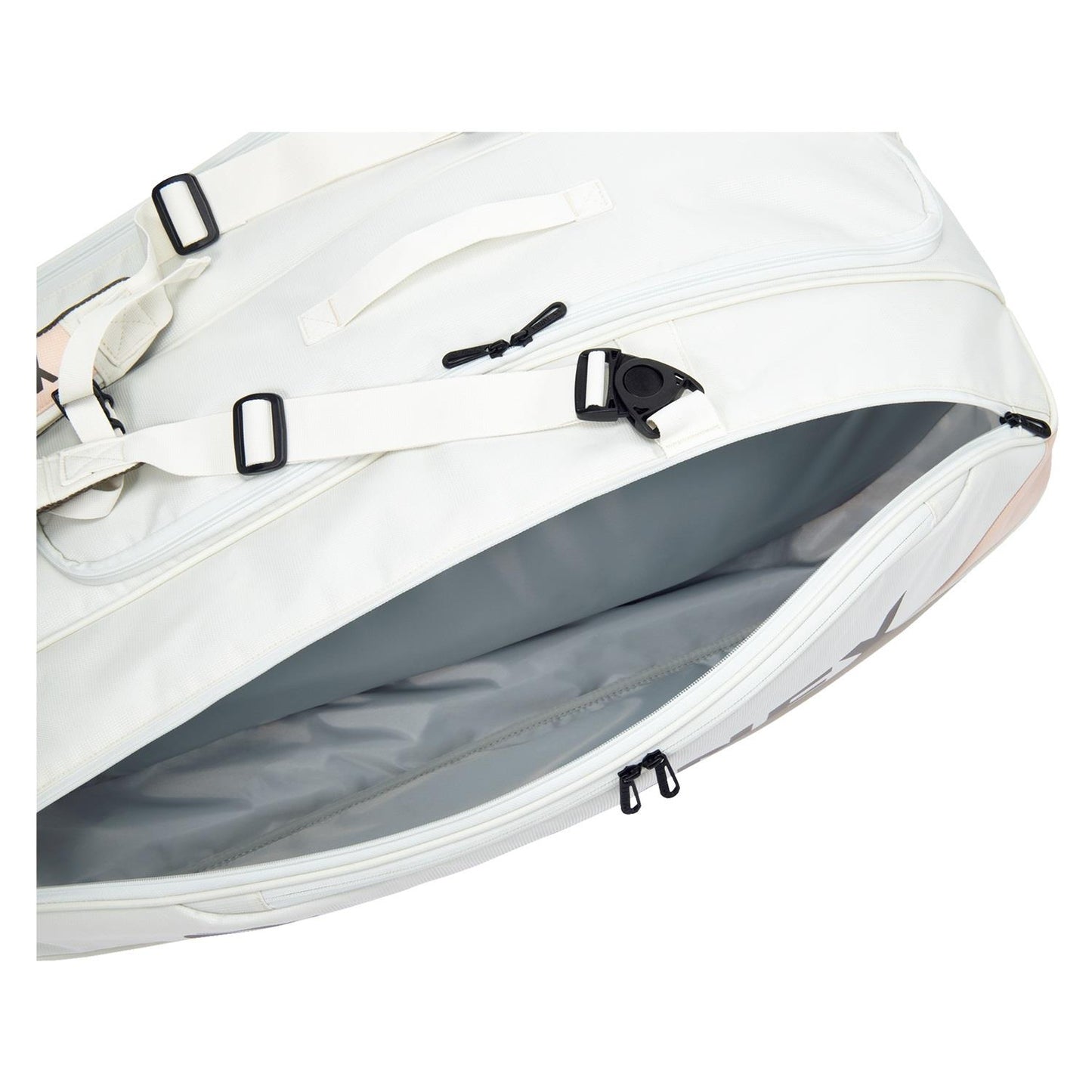 The sand beige Yonex 92429EX 9 Racket Pro Badminton Bag is open, revealing its roomy Thermo Guard lined interior. Featuring black straps, buckles, and zippers, this bag rests elegantly against a plain white background, providing both style and functionality for every badminton enthusiast.