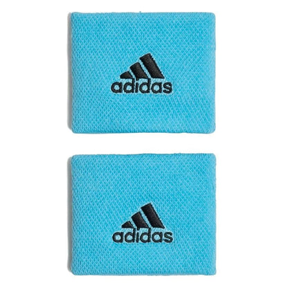 Two Adidas wristband sweatbands in blue, made from recycled materials, are showcased on a white background. Each moisture-absorbing band prominently displays the iconic adidas logo embroidered in black.