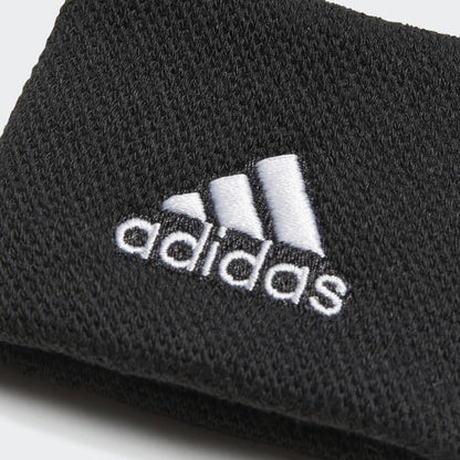 Close-up of a black fabric with the white embroidered adidas logo. Made from recycled materials, the adidas Wristband Sweatband Small - Black showcases the iconic three stripes above the lowercase "adidas," delivering both style and moisture-wicking comfort.