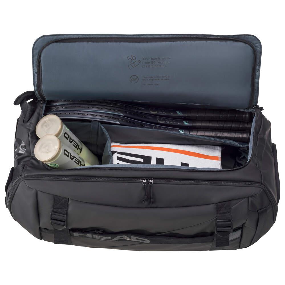 Open the HEAD Pro X Duffle Bag XL - Black by HEAD, which contains several tennis rackets, two tubes of tennis balls, and a folded towel. This eco-friendly black bag is equipped with CCT+ climate control technology and boasts a spacious interior along with convenient side compartments.