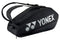 The Yonex 92426EX Pro 6 Racket Badminton Bag in black is designed for carrying sports equipment, complete with two shoulder straps and a dedicated shoe compartment. The Yonex logo is prominently displayed in white on the side.