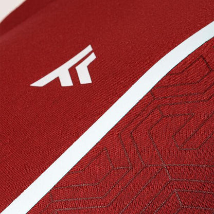 Close-up of a high-performance appearance in cardinal fabric, highlighting a subtle geometric pattern and a small white logo resembling an abstract letter "A," characteristic of the Tecnifibre Mens Team Badminton Sweater.