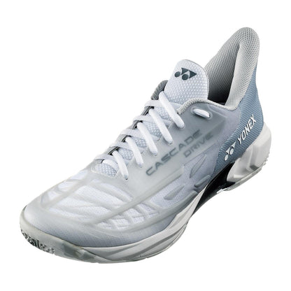 Introducing the Yonex Power Cushion Cascade Drive 2 Badminton Shoes in Matte White—a sleek and stylish pair featuring a refined white and grey color scheme. The shoes boast textured details, prominently display brand logos on the side and tongue, and have "Cascade Drive" inscribed for a distinctive touch. With a Power Cushion sole, they offer unmatched comfort during play.