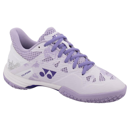 These fashionable Yonex Power Cushion Eclipsion Z3 Women's Badminton Shoes feature a white and purple color scheme, inspired by their renowned cushioning technology. The shoes showcase a geometric design with purple laces and a textured sole, perfectly blending aesthetic appeal with superior cushioning and repulsion for exceptional performance.