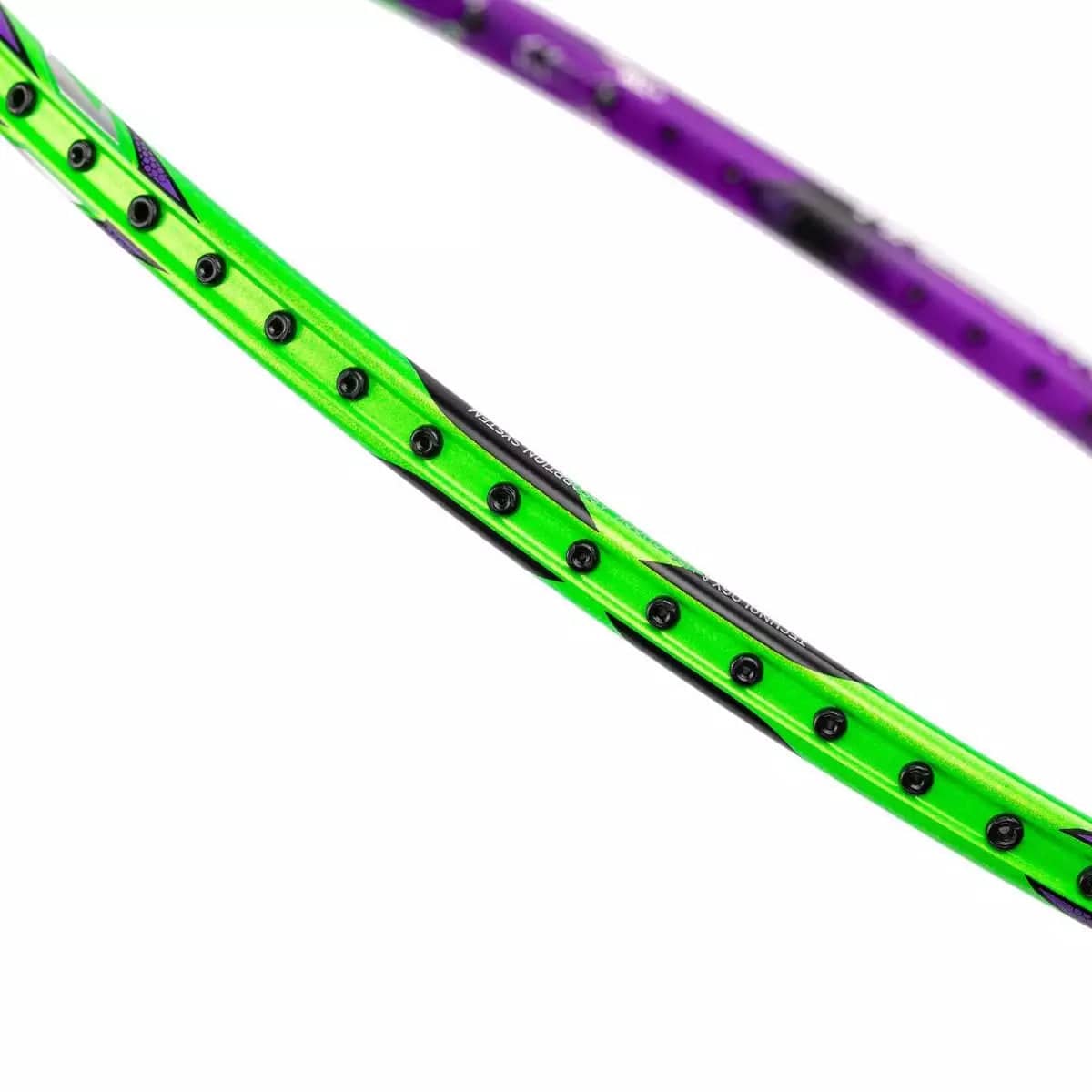 Close-up of a vibrant Li-Ning Halbertec 9000 badminton racket frame, showcasing the striking Green Crystal and Dragons Violet design with visible grommet holes for stringing. The lively colors of this high-performance racket stand out dramatically against the white background.