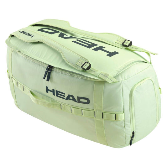 The HEAD Pro Duffle Badminton Bag M - LLAN is a light green sports duffle bag with a sustainable design, featuring the "HEAD" brand prominently in bold black on both the top and side. This badminton bag is equipped with adjustable shoulder straps, crafted from ripstop fabric for enhanced durability, and includes multiple zippers and additional side pockets for extra storage.