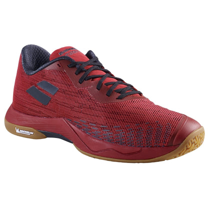 The Babolat Shadow Spirit 2 Men's Badminton Shoes in Black/Poppy Red offer an athletic design. They feature a lightweight and textured mesh material with black laces, along with a comfortable brown sole that has a slightly raised heel. The shoes are completed with the Babolat logo on the side and sole.