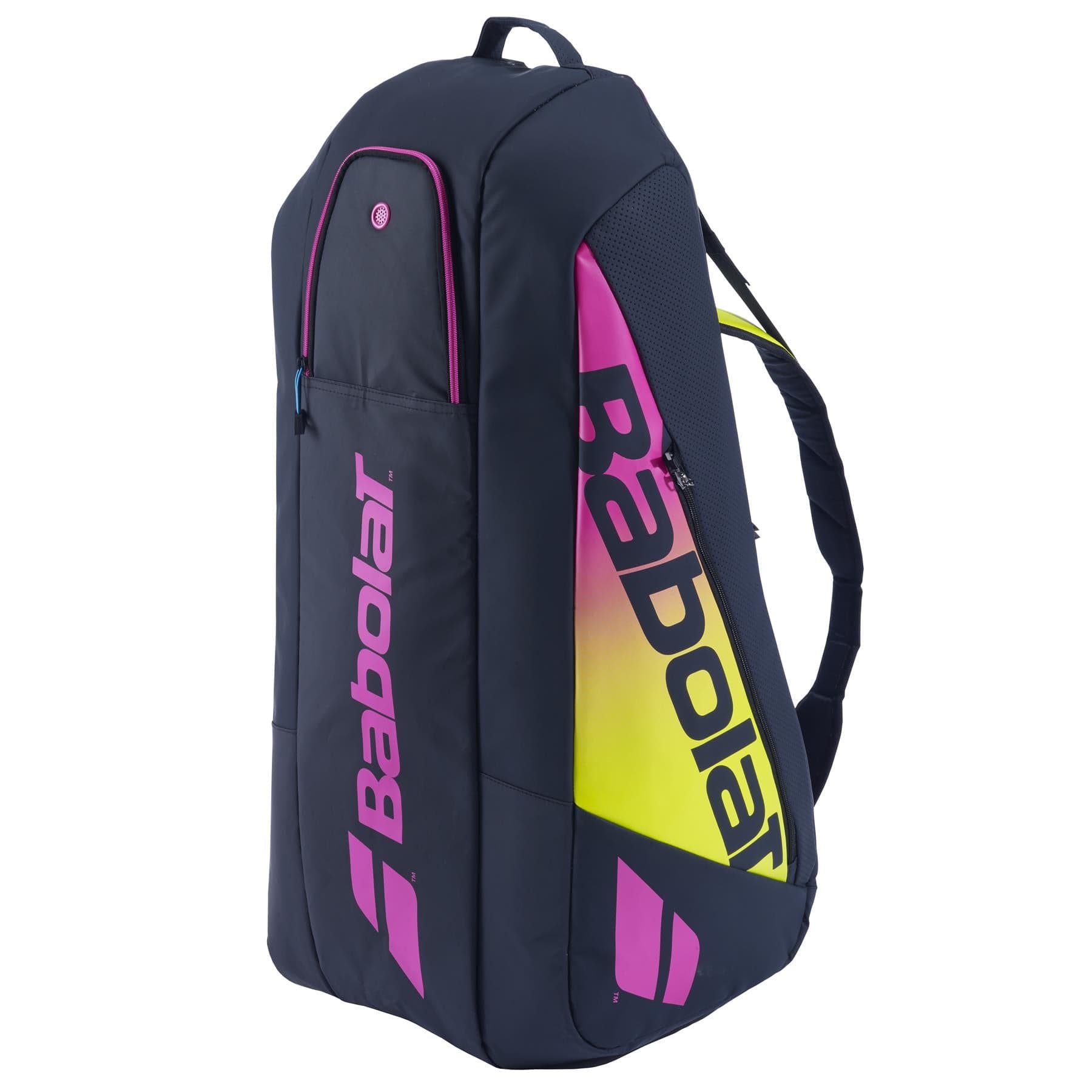 A blue, yellow, and pink Babolat backpack, designed like the RH6 Pure Aero Rafa II Badminton Bag, features multiple zippered compartments and a carrying handle.