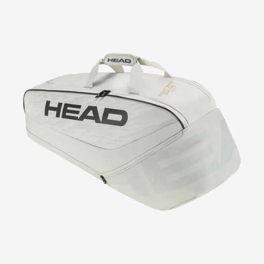 The HEAD Pro X Racket Bag - M - YUBK, in a sleek white finish with bold black "HEAD" lettering, is equipped with dual handles and zippered compartments. Drawing inspiration from the Djokovic signature line, its streamlined design incorporates advanced climate control technology to safeguard your gear.