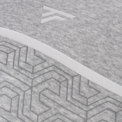 Close-up of a silver fabric with a geometric pattern featuring interlocking hexagons and lines. Above the pattern, a minimalistic logo with angled lines exudes a high-performance aesthetic. The texture of this Tecnifibre Mens Team Badminton Sweater is soft yet provides a comfortable feel.