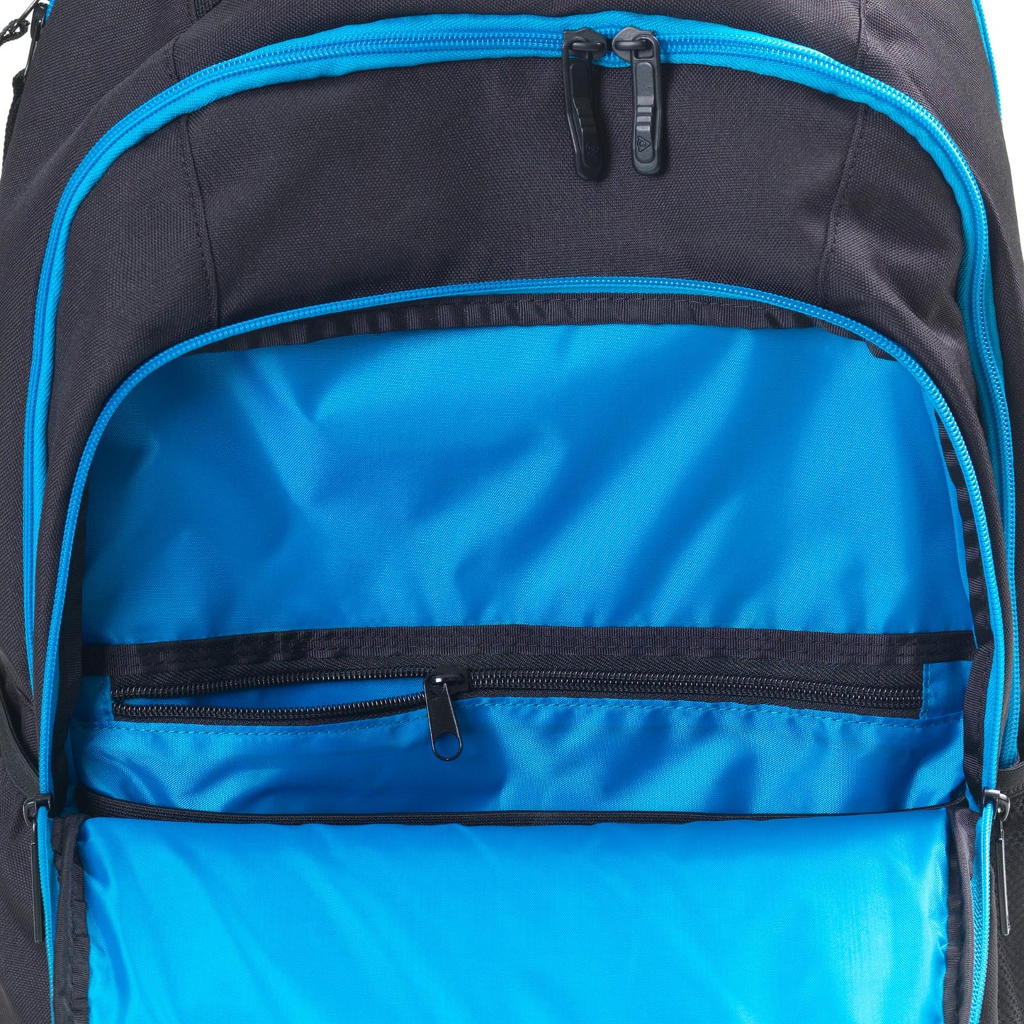 Close-up of a Dunlop FX Performance Backpack in black and blue, featuring an unzipped main compartment that reveals a vibrant blue interior. The interior design includes a black zipper pocket and additional zipped compartments, offering striking contrast against the backpack's dark exterior.