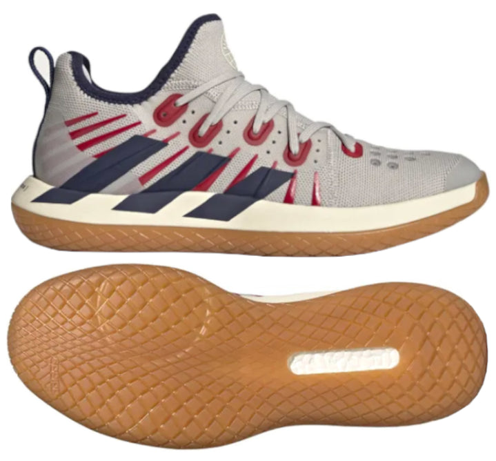 Explore the ADIDAS Stabil Next Gen 2.0 Primeblue, an indoor badminton shoe crafted in a chic gray with eye-catching red and navy touches. Designed by adidas, these shoes boast a mesh upper for breathability and incorporate BOOST technology for exceptional comfort. Complete with white laces and a gum-colored sole featuring a textured pattern, these shoes are presented from side and bottom viewpoints to fully admire their design.