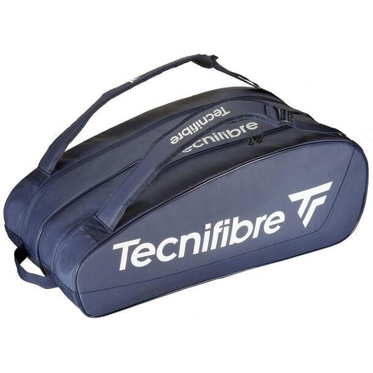 The Tecnifibre Tour Endurance 2023 12 Racket Badminton Bag in navy blue, made from durable tarpaulin fabric, offers a spacious zippered main compartment and an adjustable shoulder strap. The bold white Tecnifibre brand name along the side ensures both style and functionality.