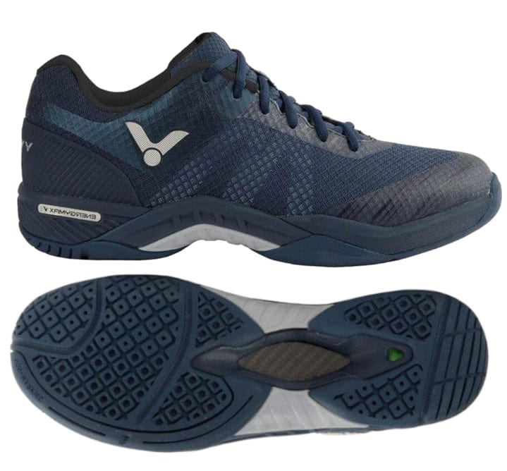 The Victor S82 Men's Badminton Shoes, by the brand Victor, come in a Medieval Blue color. They are designed with breathable mesh for enhanced comfort and wear-resistant TPU to ensure durability. A side view highlights the lace-up design and distinct logo, while the bottom reveals a tread pattern that improves grip and support.