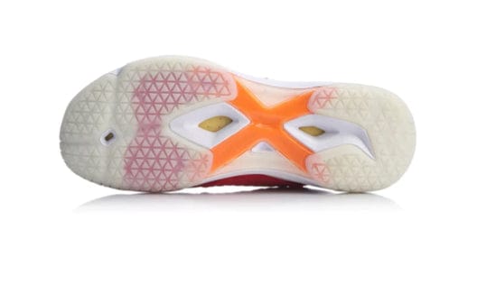 The bottom view of the Li-Ning Dagger II SE Mens Badminton Shoe reveals a sneaker sole with a geometric tread pattern reminiscent of traditional badminton shoes. It features a primarily white sole highlighted by an orange X-shaped design in the center and translucent sections near the heel, all enhanced with sleek Tuff-Tip Technology to boost athletic performance.