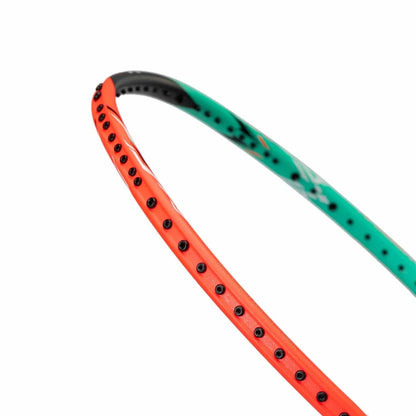 Close-up of the Li-Ning Halbertec 7000 4U Badminton Racket in Arcadia and Orange Juice colors, highlighting the vibrant orange inner edge paired with a green outer edge. Its black grommet holes emphasize a sleek, modern design.