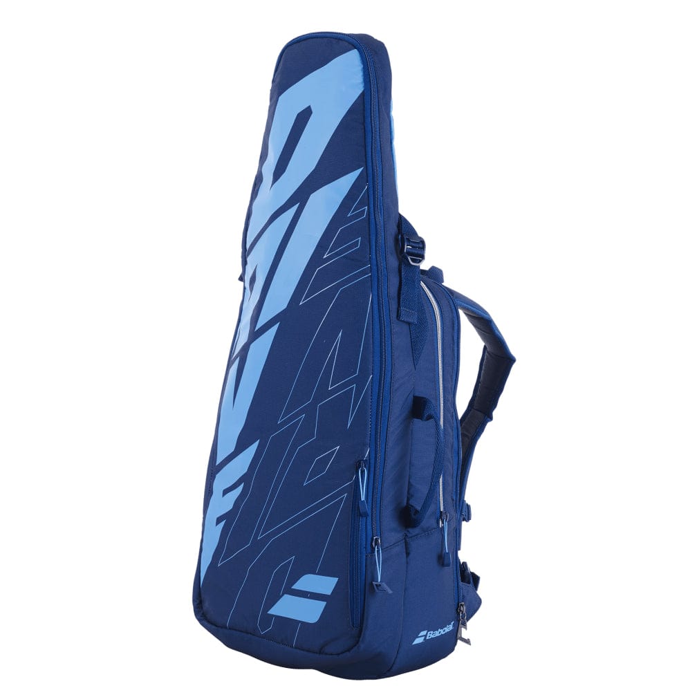 The Babolat Pure Drive Backpack - Blue from Babolat is designed with prominent light blue lettering on the side and several zippered compartments, including an isothermal insulated compartment. Perfect for carrying badminton equipment, it also features adjustable shoulder straps for convenient transport.