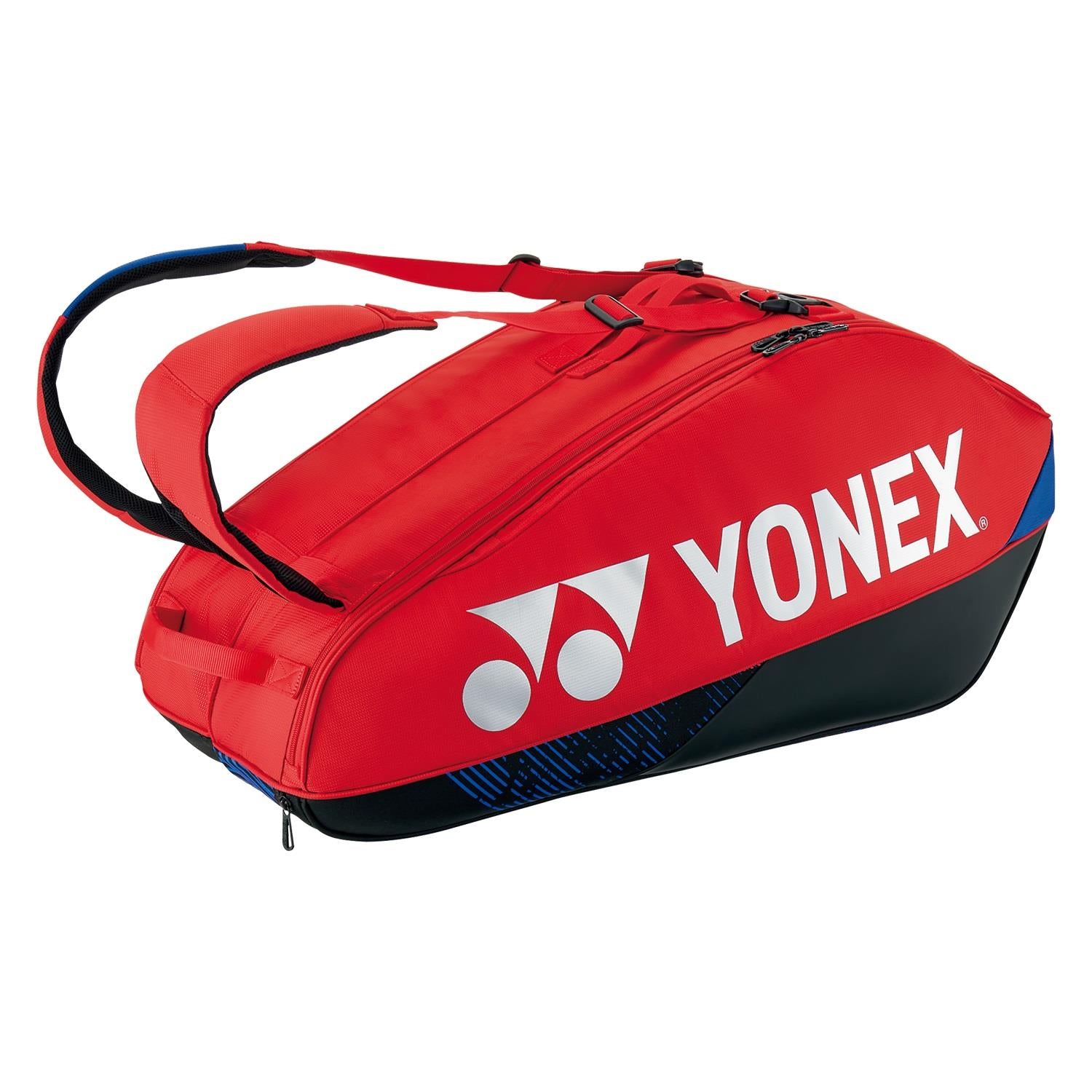 A Yonex 92426EX 6 Racket Pro Badminton Bag in Scarlet, featuring a white logo and text with a black base and blue accents. It includes adjustable shoulder straps and multiple compartments, including a shoe compartment, perfect for carrying your tennis gear.