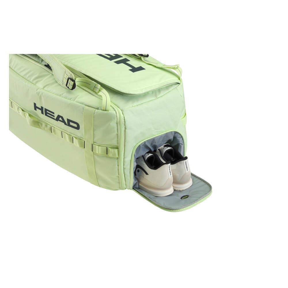 The light green HEAD Pro Duffle Badminton Bag L - LLAN by HEAD serves as a badminton bag and reveals an unzipped section containing two white sneakers with black inner detailing.