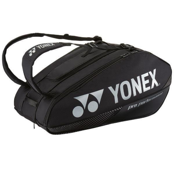 The Yonex 92429EX 9 Racket Pro Badminton Bag - Black is a sleek design featuring multiple compartments and a comfortable shoulder strap. The brand name "Yonex" and its logo are elegantly printed in white on the side, making it perfect for carrying all your essentials.