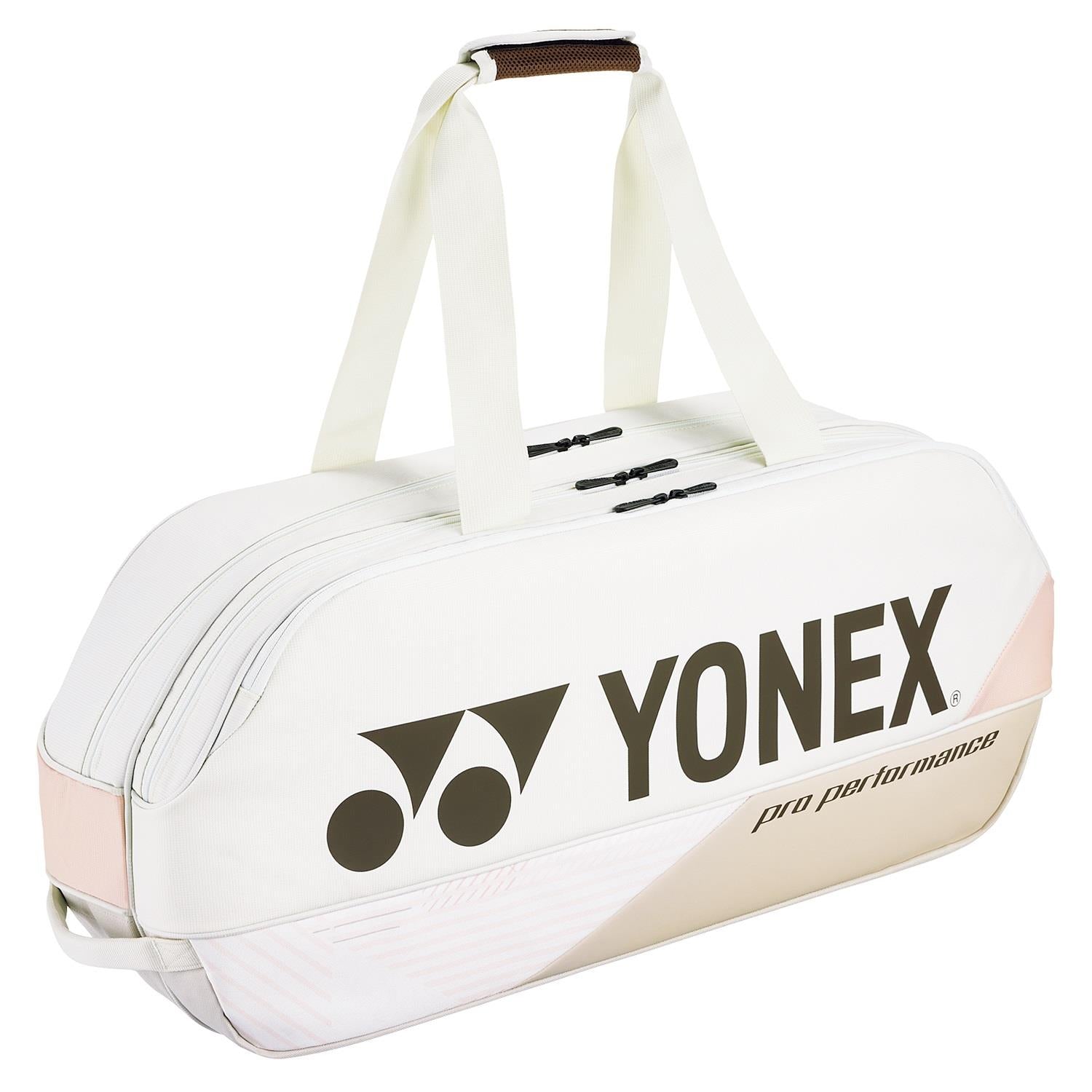 The Yonex 92431WEX Pro Tournament 6 Racket Badminton Bag in Sand Beige features sleek black logos and dependable YKK zippers. Designed for the serious athlete, it includes two sturdy handles for easy carrying and multiple zippered compartments, seamlessly merging style with functionality.