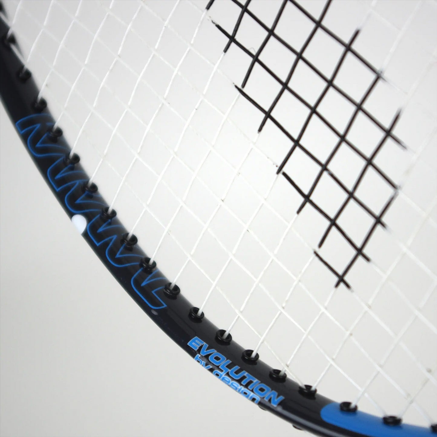 The Karakal CB-3 2.1 Badminton Racket showcases a close-up of its head, featuring black strings and a sleek black frame adorned with blue accents. The word "EVOLUTION" is prominently printed in blue on the side, echoing an isometric head design, making it perfect for those transitioning from a beginner badminton racket.