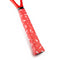 Close-up of the Get A Grip Charged Up Badminton Overgrip in red, wrapped around a racquet handle and featuring a distinctive pattern of white lightning bolts.