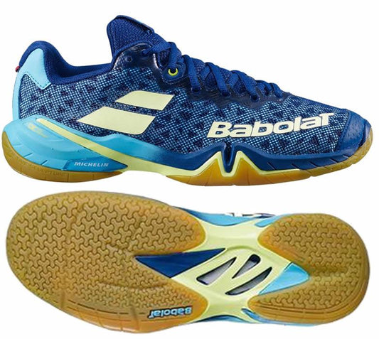 Introducing the Babolat Shadow Tour Badminton Shoes by Babolat in eye-catching blue and yellow. These athletic shoes feature DCS technology for enhanced shock absorption. With a textured, non-slip sole showcasing the "Michelin" logo and a breathable mesh upper, they are ideal for intense workouts.