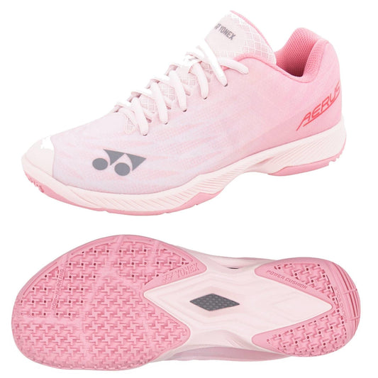 The Yonex Power Cushion Aerus Z2 Women's Badminton Shoes in light pink offer a lightweight design ideal for badminton. Featuring a classic lace-up top view and the Yonex Power Cushion non-marking textured sole, these shoes prioritize traction and support on the court.