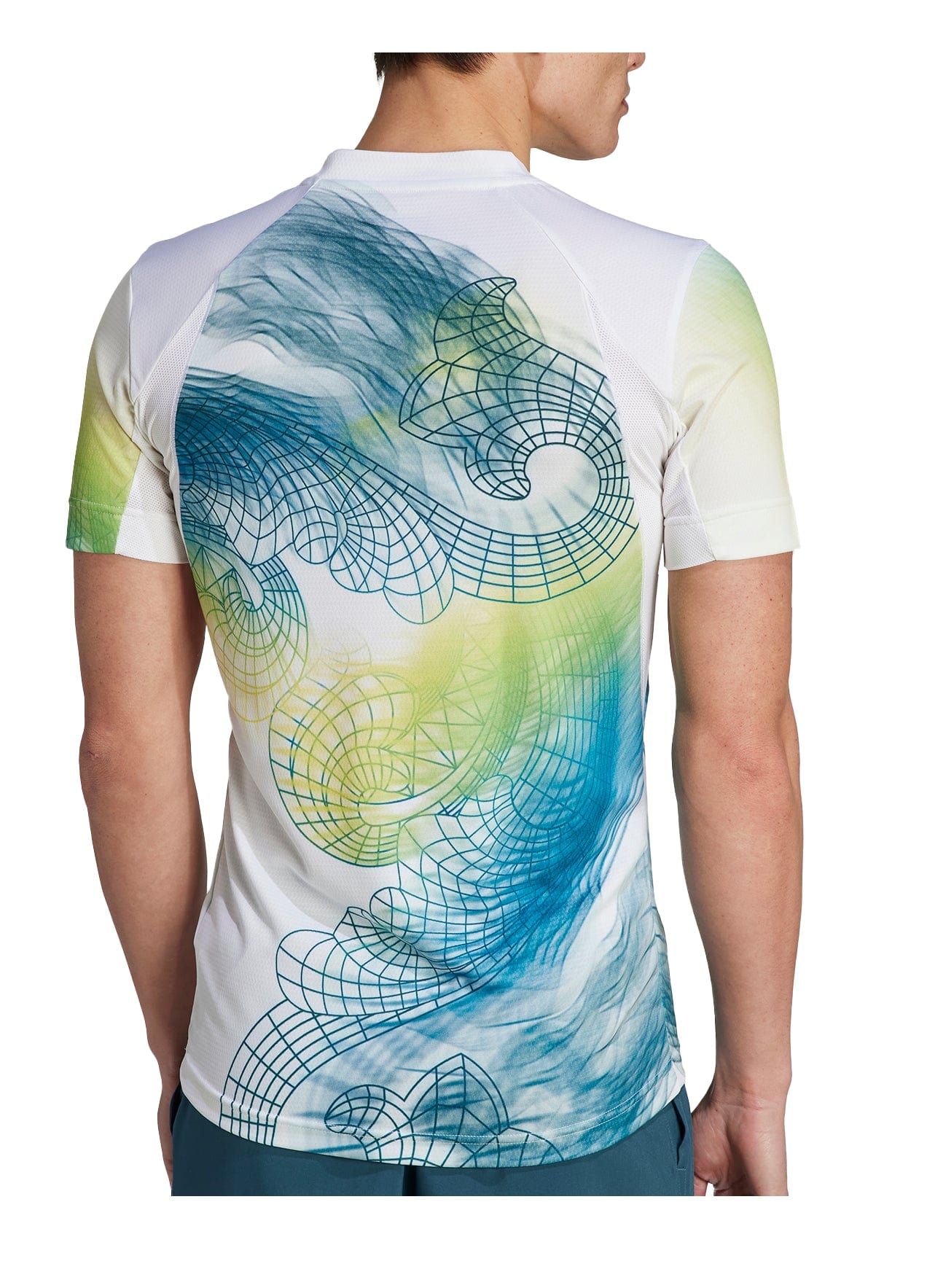 An individual is facing away, wearing an adidas Men's Printed Aeroready Freelift Pro Badminton T-Shirt in white, which features a colorful abstract design on the back with blue, green, and yellow swirling patterns intertwined with geometric wireframe shapes.