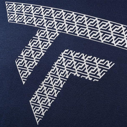 Close-up of a navy blue fabric showcasing a geometric white pattern similar to the chic designs found on the Tecnifibre Fleece Unisex Badminton Hoodie - Marine. The design highlights intersecting lines that form intricate shapes, creating a stylized letter "T" in both vertical and horizontal layouts.