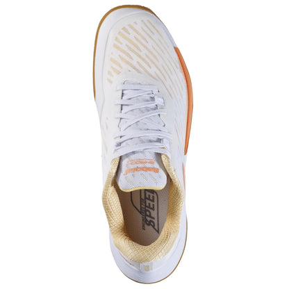 Top view of the Babolat Shadow Tour 5 Women's Badminton Shoe in white and yellow. This lightweight shoe showcases a textured body, lace-up design, and a tan interior with the word "Speed" visible on the inner sole.