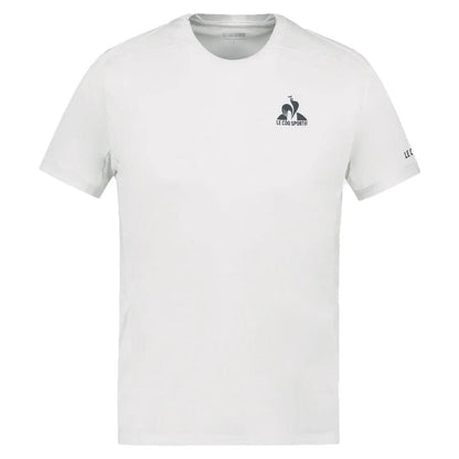 The Le Coq Sportif Pro Men's Badminton T-Shirt in Optical White, from the K-Swiss brand, showcases a minimalist design with a small "Le Coq Sportif" logo on the upper left chest. Made from breathable polyester, it features a stylized rooster and is designed with short sleeves to highlight simplicity, comfort, and ease of movement.