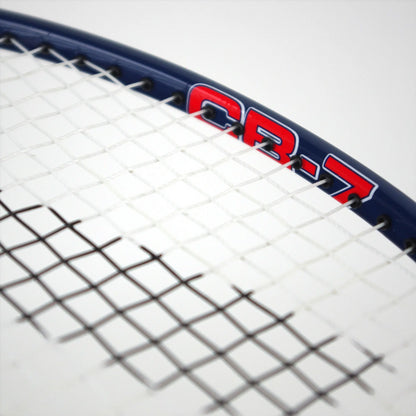 Close-up of a Karakal CB-7 2.1 badminton racket, showcasing an isometric head and a blue graphite frame with red "CB-7" lettering on the head. The strings are tightly woven, set against a plain white background.
