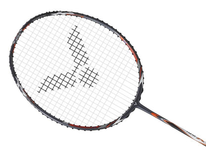 The Victor Auraspeed 100X H badminton racket by Victor showcases an eye-catching grey and orange frame design. Its strings display a geometric logo pattern at the center, enhanced with Sonic-Rebound Technology, while the racket is shown diagonally against a white background.