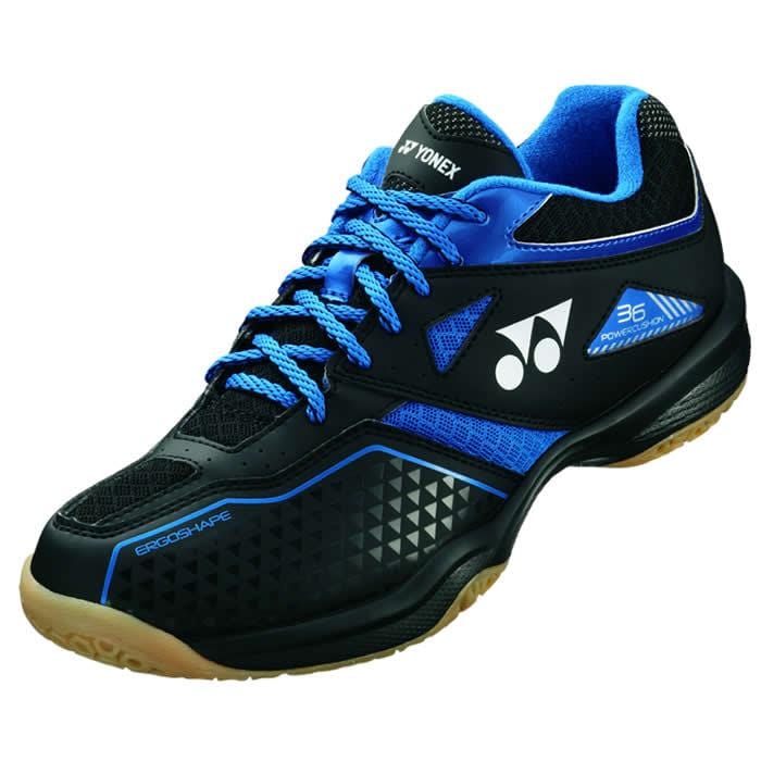 Introducing the Yonex Power Cushion 36 Men's Badminton Shoes in Black and Blue. These shoes are crafted with Yonex's Power Cushion technology for enhanced comfort, featuring a textured sole and prominent branding on the sides and tongue. Designed with an Ergoshape construction, they offer excellent support on the court.