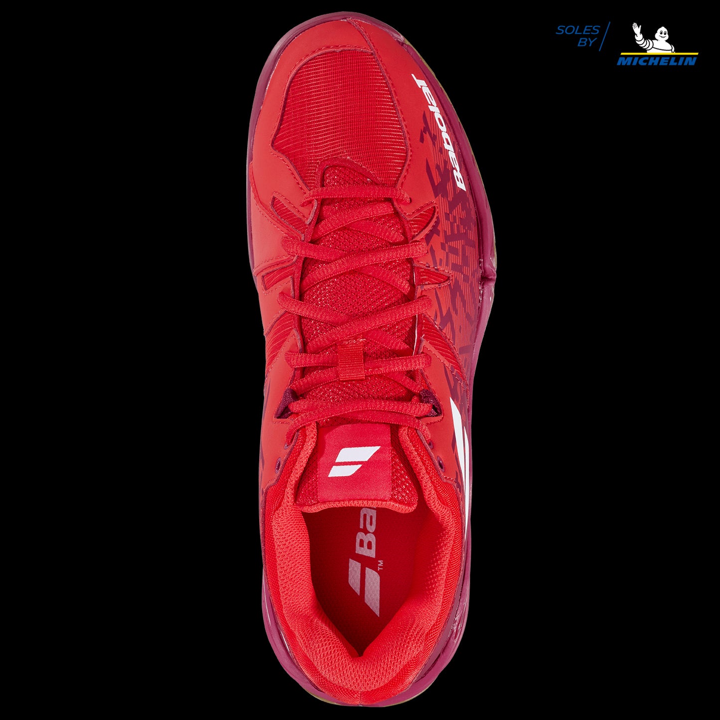 Here's the revised sentence incorporating the provided product data:

Top view of the Babolat Shadow Spirit Men's Badminton Shoes in Cherry Tomato, featuring white branding on the tongue and side. The shoes showcase a textured design with a lace-up closure. Crafted with Michelin rubber for the gripsole, as highlighted in the top right corner, they ensure exceptional performance and durability.