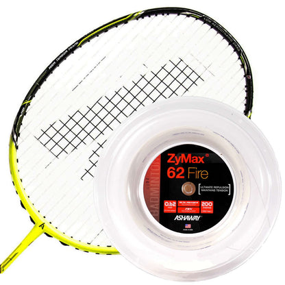 A yellow and black badminton racket is placed beside a reel of Ashaway Zymax 62 Fire Badminton String in white, known for its maximum repulsion prized by professional players, with the label displaying specifications in white, red, and black text.