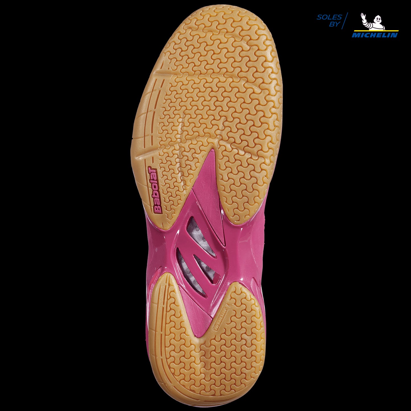 The image displays the sole of a Cherry Tomato Babolat Shadow Spirit men's badminton shoe, equipped with tan Michelin rubber treads designed for superior grip and durability. The "MICHELIN" logo is prominently positioned at the top right corner, emphasizing the innovative design collaboration with Babolat.