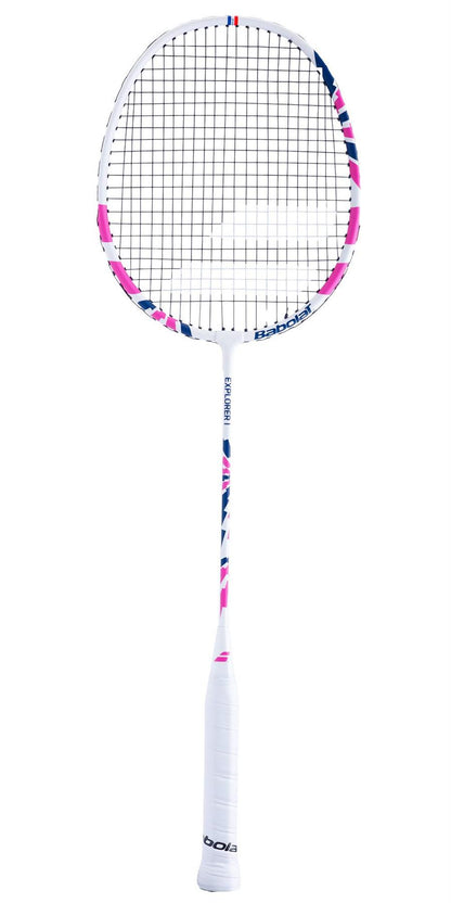 The Babolat Explorer I Badminton Racket in a white and pink color scheme is ideal for beginners, featuring a string grid and a thin handle wrapped with white grip tape. Constructed from aluminum and steel, the frame showcases the Babolat brand logos against its plain white background.