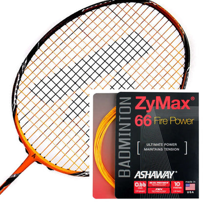 A badminton racket featuring orange and black strings is displayed beside a packet of "Ashaway Zymax 66 Fire Power Badminton String Orange - 0.66MM - 10m Packet." This highlights its role as a high-performance string designed for ultimate power and optimal repulsion. Made in the USA, these strings ensure consistent tension for peak performance.