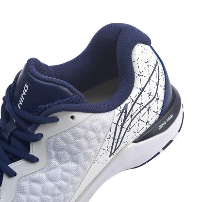 Close-up of the Li-Ning Dagger II SE Mens Badminton Shoe, showcasing its textured white upper, navy blue laces, and navy blue collar. The design includes abstract lines and "Drive Foam" inscribed on the sole, complemented by TUFF-TIP accents for enhanced durability.