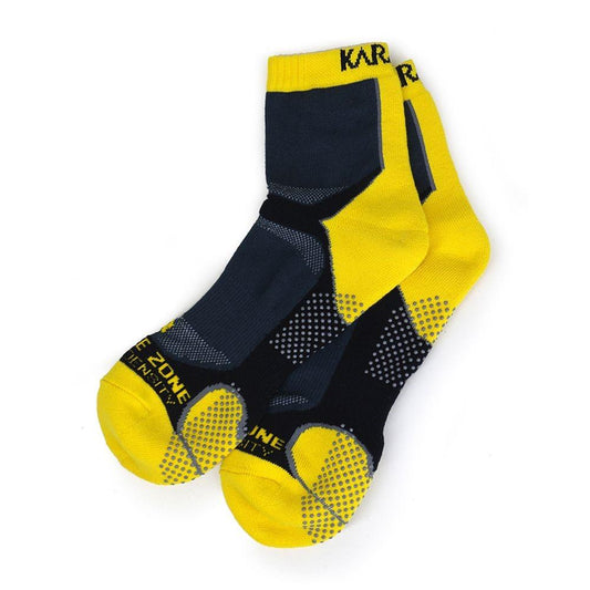 The Karakal X4 Men's Technical Ankle Badminton Socks, available in black and yellow for sizes UK7-UK13, are made from Cool Tec material to improve breathability. They feature textured soles and black grip dots for shock-absorbing comfort, with the word "ZONE" elegantly displayed on the toe area.