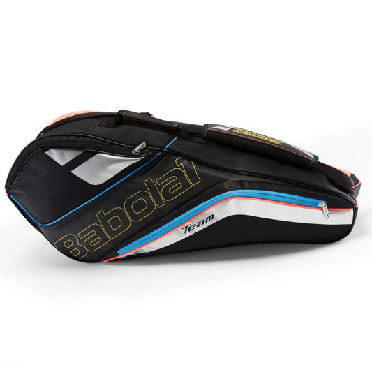 The Babolat RHX4 Team Line Badminton Racket Bag from Babolat is a sleek black bag accented with blue, red, and white colors. Ideal for recreational players, it is designed to hold up to four rackets along with other gear. It features several zippered compartments, with a stylish "Team" logo on one side.