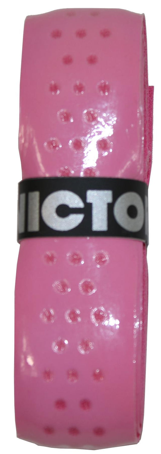 Close-up of a self-adhesive perforated grip wrap for sports equipment, rolled up with a black band in the center displaying the word 'VICTOR' in bold white letters. This Victor Soft Grip Replacement Badminton Grip - Pink (single) offers an enhanced feel, perfect for improving your game.