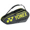 The Yonex 42126EX Team 6 Piece Badminton Racket Bag in black and yellow offers a spacious storage compartment for up to six rackets. It features the word "TEAM" on the side and includes an adjustable shoulder strap for convenient carrying.