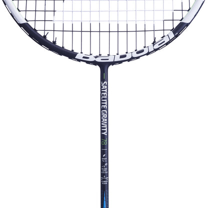 A close-up of a black and white Babolat Satelite Gravity 78 Badminton Racket showcases the specialist strings and prominent branding, including the model name. The handle is enhanced with Babolat's SLIM T technology and features green and blue design accents against a plain white background.